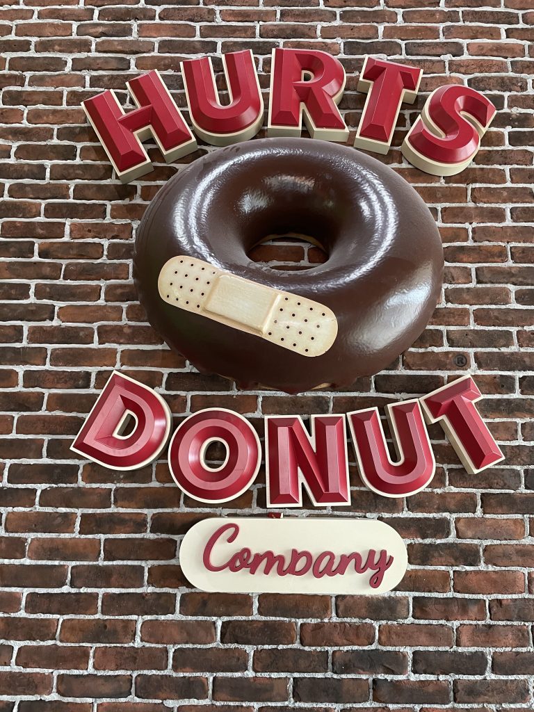 Lobby signs for Hurts Donut by Premier Signs & Graphics in Dallas, TX